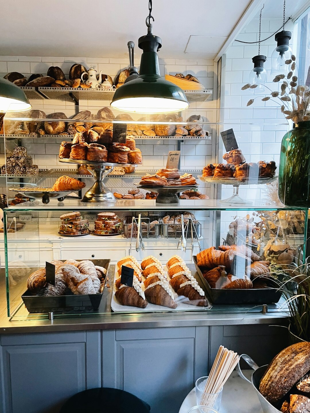 Baker arranging fresh bread in a local Danish bakery