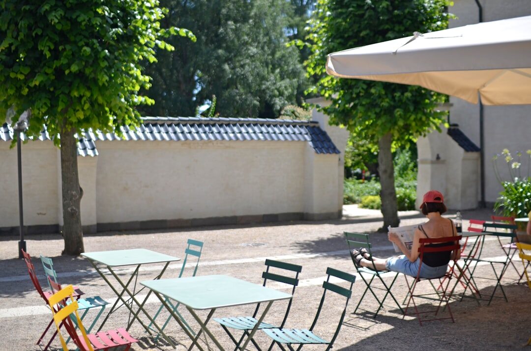 Woman reading a newspaper at a Danish cafe