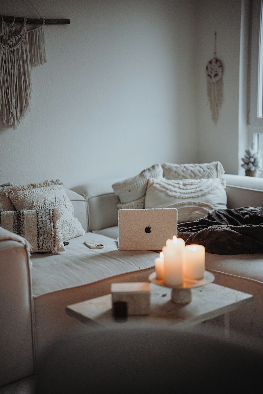 Cozy Danish living room with candles and knit blankets